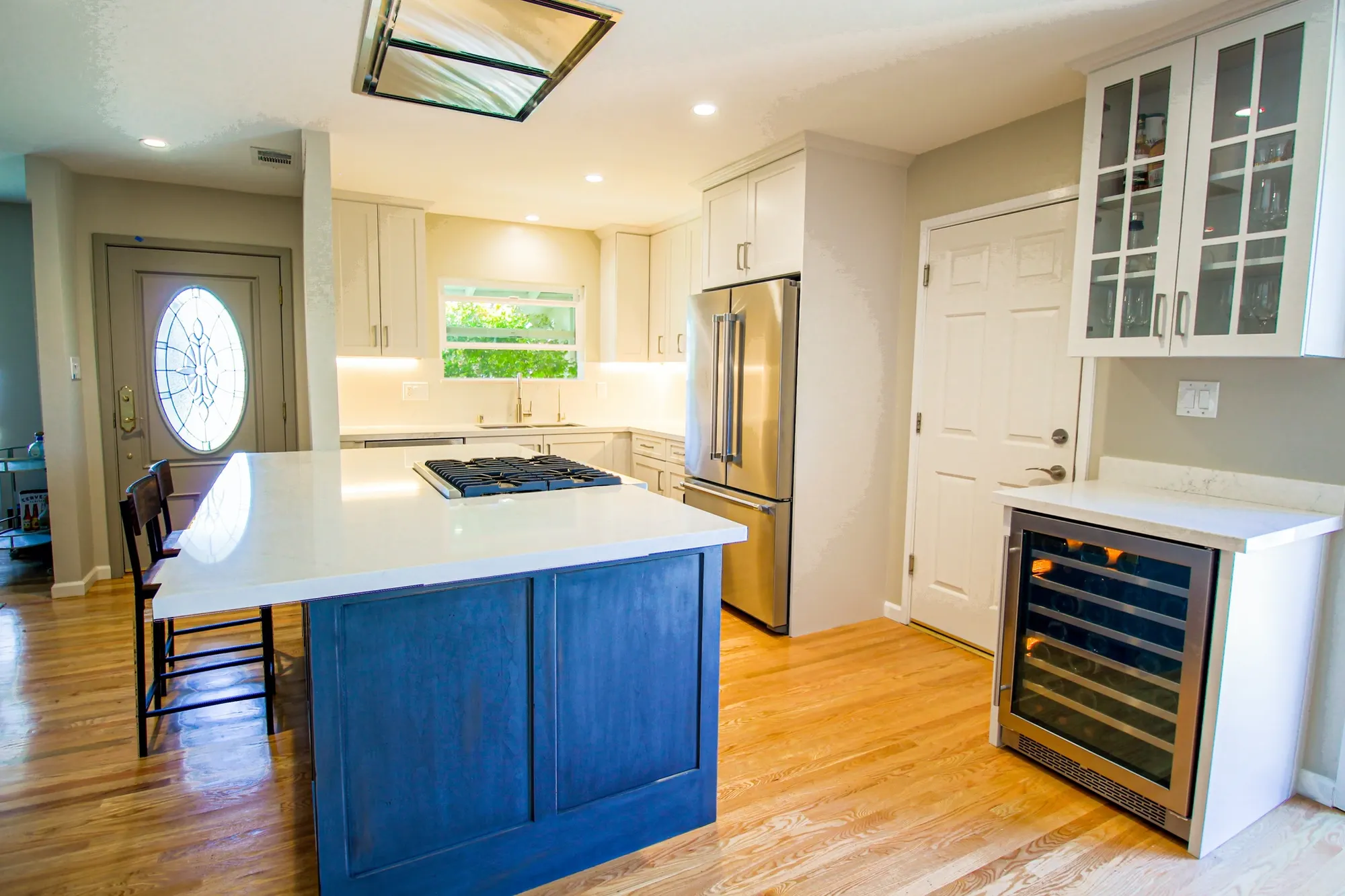 Kitchen with a blue island and quartz counters