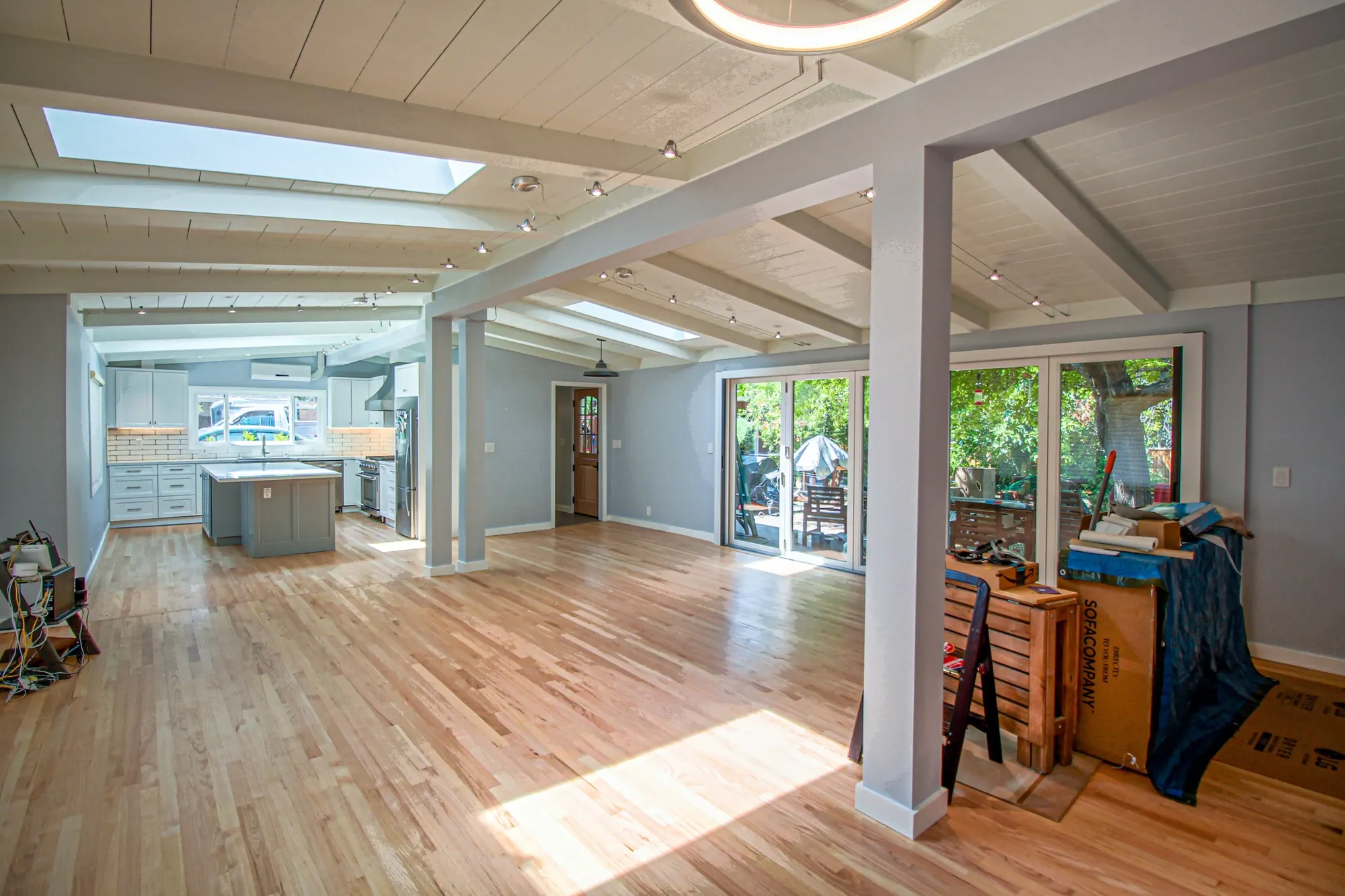 Open-plan living space with new oak floors and skylights
